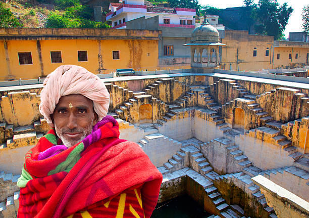 India Jaipur, man at step well, Amber fort