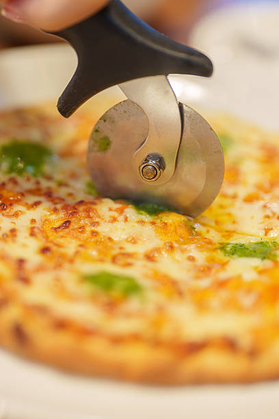 Homemade Margherita pizza with basil, mozzarella, and cherry tomatoes on plate
