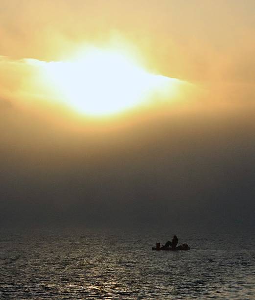 Sunset over a lone fisherman