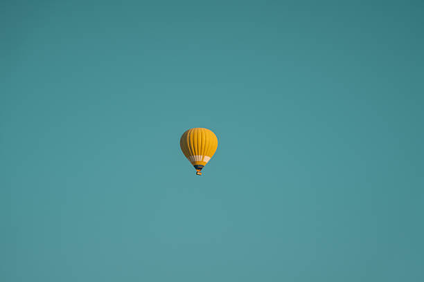 Cappadocia hot air balloons drifting above soft rock formations, featuring warm tones, calm skies, and iconic valley scenery.
