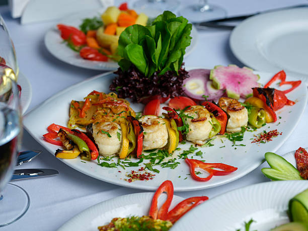 Grilled sole fish and peppers served on a skewer in a luxury seafood restaurant