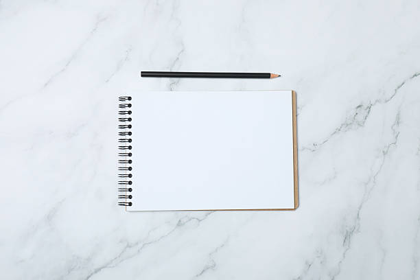 istock Notepad with spring on the table with pencil and coffee. Office concept. Top view. 2254855957