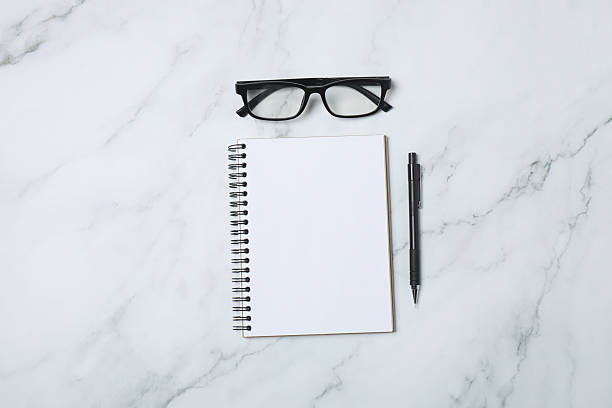 istock Notepad with spring on the table with pencil and coffee. Office concept. Top view. 2254856018