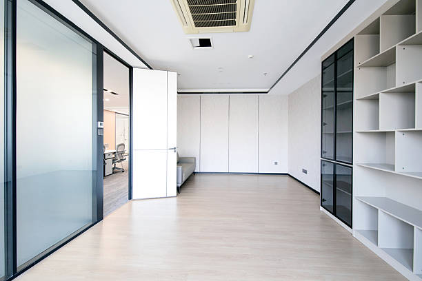 A sofa sits in the corner of the empty office.
