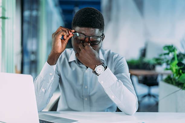 istock Stressed businessman having headache while working on laptop in the office. 2254861559