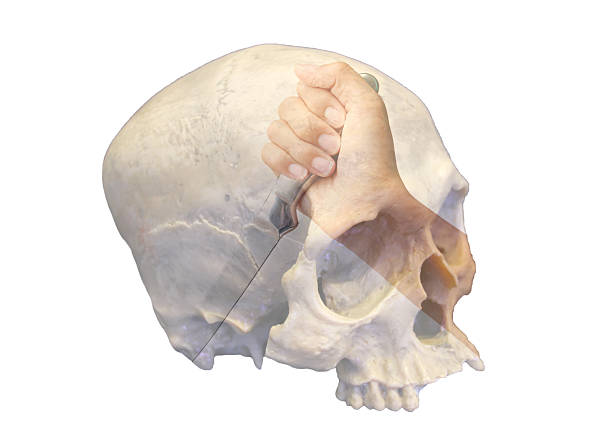 A conceptual double exposure image of a human hand holding a knife superimposed over a human skull.