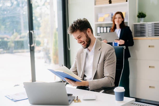 istock Two business workers talking on the smartphone and using laptop 2254862342