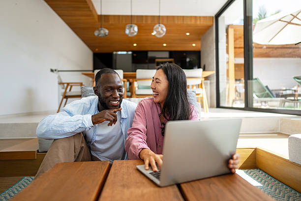 istock Remote work and digital business. Diverse couple collaborating online, managing projects with laptop 2254864497
