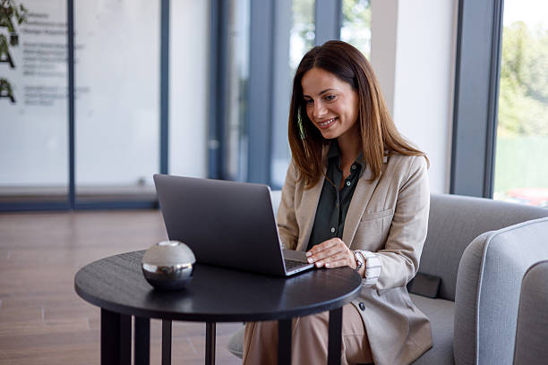 istock Businesswoman telecommuting, using laptop for remote work, enjoying flexible schedule and modern office environment 2254866973