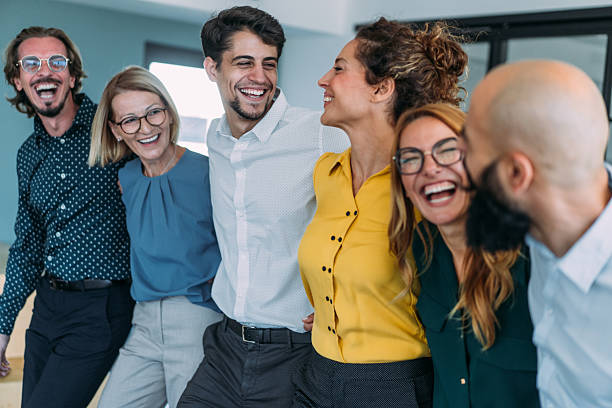 istock Excited coworkers embracing each other during a celebration in the office. 2254867930
