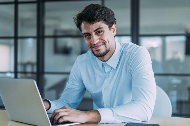 istock Successful businessman in modern office working on laptop. 2254867952