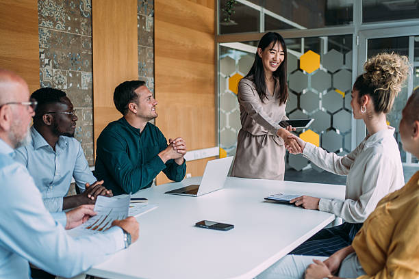 istock Businesspeople shaking hands across the table. 2254868378