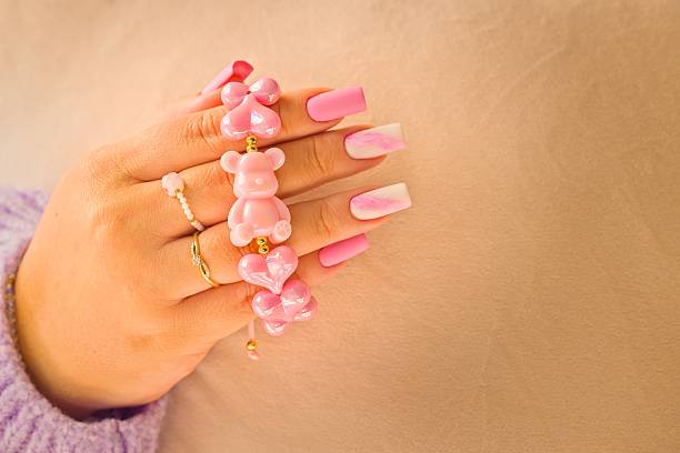 Fashion lifestyle close-up showcasing feminine hands, matte pastel manicure and refined jewelry styling.