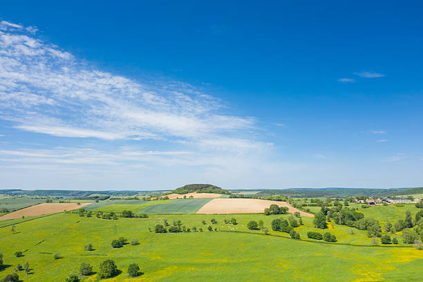 istock Vivid farmland and small hill under clear blue sky 2254869310