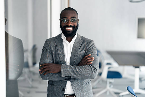 istock Smiling confident businessman standing in modern office 2254869319