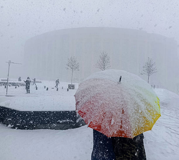 Walking under heavy snow with umbrellas
