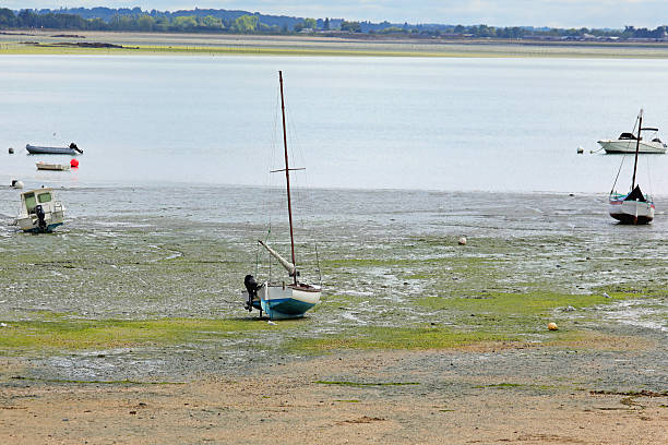 stranded boat on sand without water during low tide northern france
