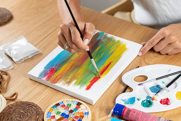 istock Woman painting at home using simple craft tools. Highlights calm focus, creative expression, and structured hobby practice in a relaxed environment. 2254873360