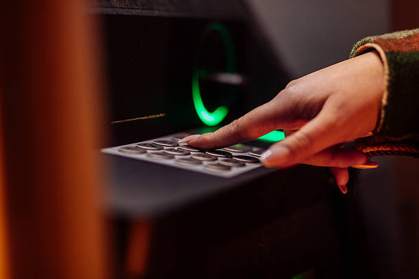 istock Close-up of a woman's hand entering a PIN code on a keypad with a green light 2254876572