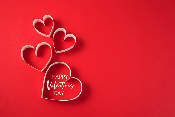 istock Valentine's Day background with paper hearts on red background 2254881108