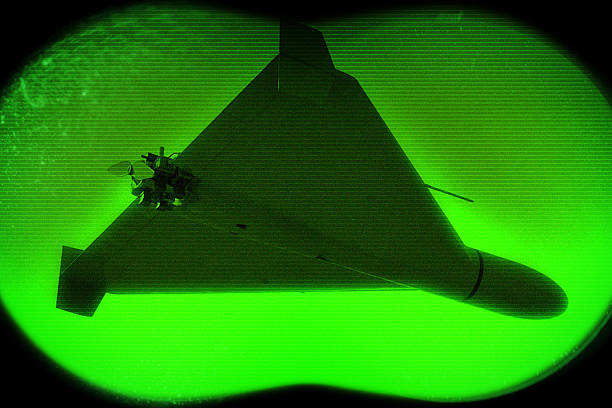 A military drone in night surveillance mode with a green screen
