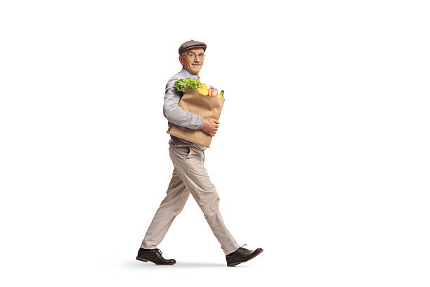 istock Smiling senior man walking with a grocery bag 2254889622