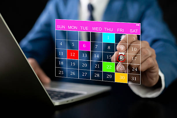 istock Businessman manages time for effective work. Calendar on the virtual screen interface. 2254890818