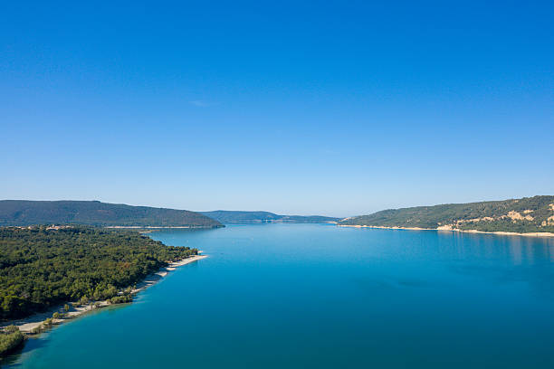 istock Expansive lake with clear blue sky and hills 2254894744