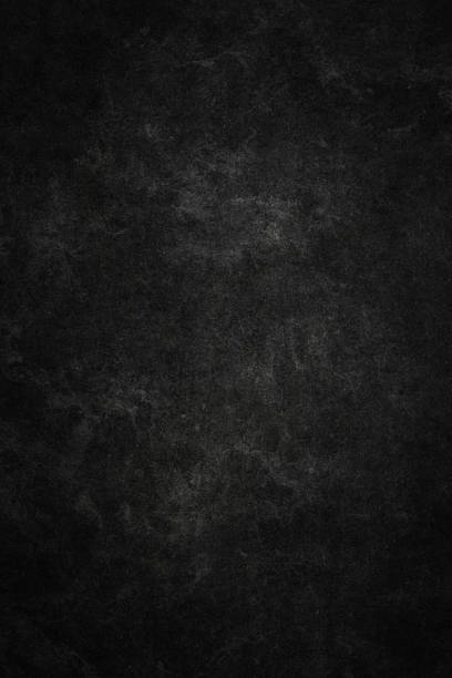A dark, textured background featuring a gritty, high-contrast black and gray surface, offering a versatile backdrop with ample copy space for various design projects, including web layouts, posters, or dramatic artistic presentations.