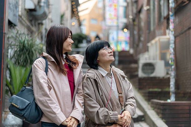 Family looking up on steps in city