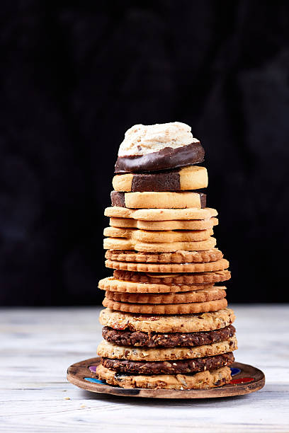 istock Stack of assorted cookies on white wooden boards 2254900929