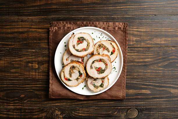 Sliced diet pork roll stuffed with mushroooms, red bell pepper, spinach