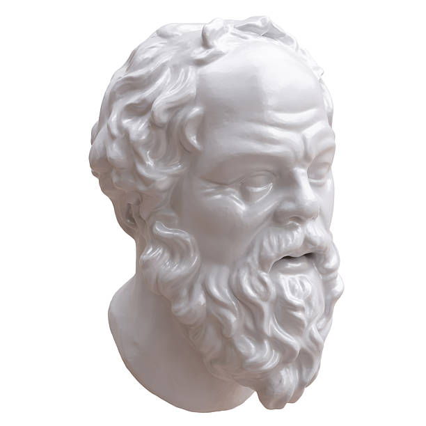 This image features a classical-style bust placed on a neutral background, partially coated with bright yellow and blue paint that creates a bold contrast against the sculpted details. Surrounding the bust are painting tools, containers with mixed pigments, a lemon, and a small plant cutting, all arranged on a studio table that reflects an active creative process. The composition highlights artistic experimentation, modern reinterpretations of classical art, and the vibrant atmosphere of a contemporary workspace where color, texture, and form intersect.
