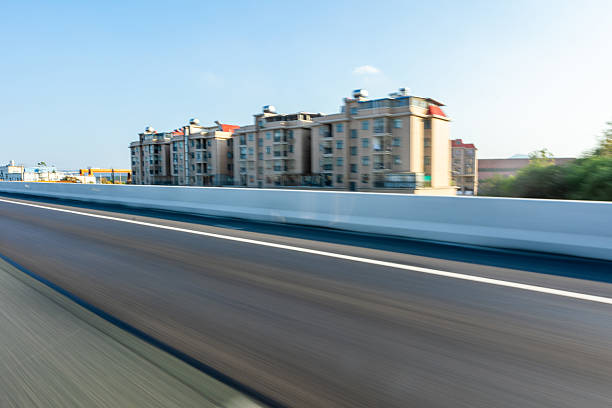Urban cityscape ground perspective with distant CBD skyline as background, clean copy space for car advertising design, modern city scenery suitable for commercial promotion, transportation branding, outdoor marketing visuals and minimalist advertising layout concept