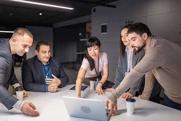 istock Diverse business team collaborating over laptop in modern office 2254914453