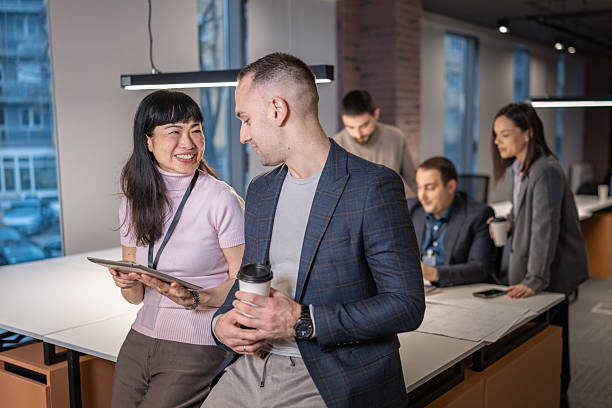 istock Business colleagues discussing project on digital tablet in modern office space 2254914897