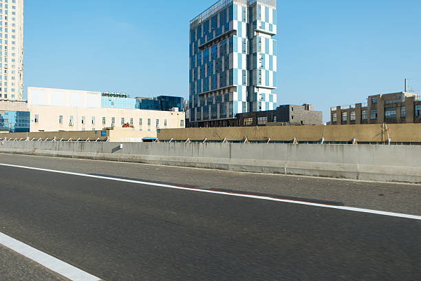 Urban cityscape ground perspective with distant CBD skyline as background, clean copy space for car advertising design, modern city scenery suitable for commercial promotion, transportation branding, outdoor marketing visuals and minimalist advertising layout concept