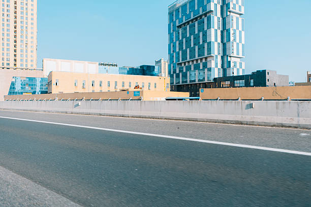 Urban cityscape ground perspective with distant CBD skyline as background, clean copy space for car advertising design, modern city scenery suitable for commercial promotion, transportation branding, outdoor marketing visuals and minimalist advertising layout concept