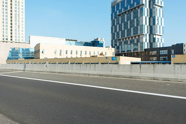 Urban cityscape ground perspective with distant CBD skyline as background, clean copy space for car advertising design, modern city scenery suitable for commercial promotion, transportation branding, outdoor marketing visuals and minimalist advertising layout concept