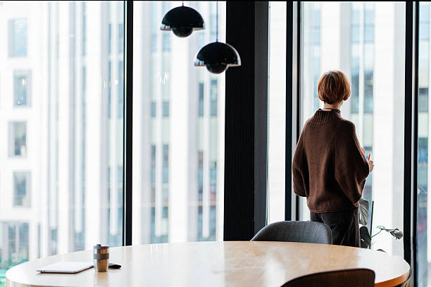 istock 50 year old woman reflecting before decision in modern office 2254922617