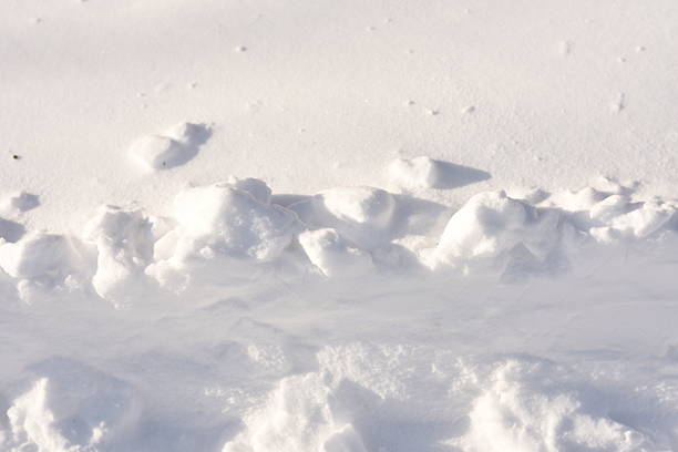 Top half shows smooth white snow, bottom part features a plowed snowdrift. Minimal winter background, snow texture, copy space.