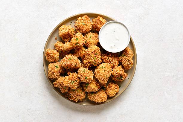 istock Crispy breaded oven baked cauliflower bites served with dipping sauce 2254930545