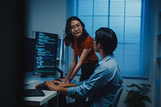 istock Tech team Asian professionals collaborate discuss software development strategies late night in modern office. Working late, software developer, artificial intelligence and programming concept. 2254931864