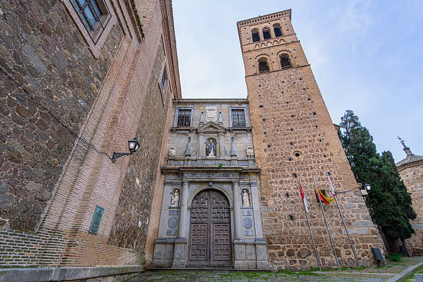 TOLEDO, SPAIN - MARCH 14, 2025: A view of the ancient stone church and bell tower with medieval architecture in the historical center of Toledo.