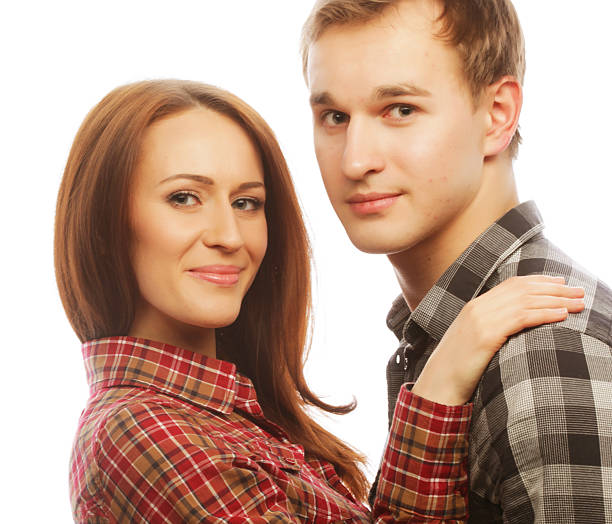 Close up outdoor portrait of middle age woman and man caucasian couple in sunny green garden