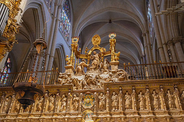 Toledo, Spain - March 14, 2025: Intricate golden sculptures and gothic arches inside the Toledo Cathedral, a major historic religious landmark.