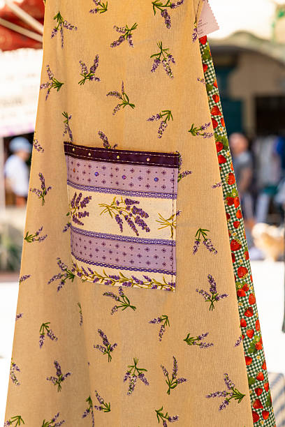 Lavender pattern apron hanging at an outdoor market stall in Nyons, France