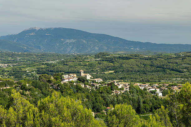 Vinsobres village sitting among green hills and vineyards with Mont Ventoux in the background