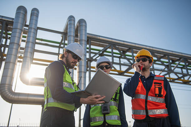 istock Industrial Engineers Inspecting Construction Site with Laptop, engineering teamwork, industrial inspection, project management and modern construction technology. 2254935658
