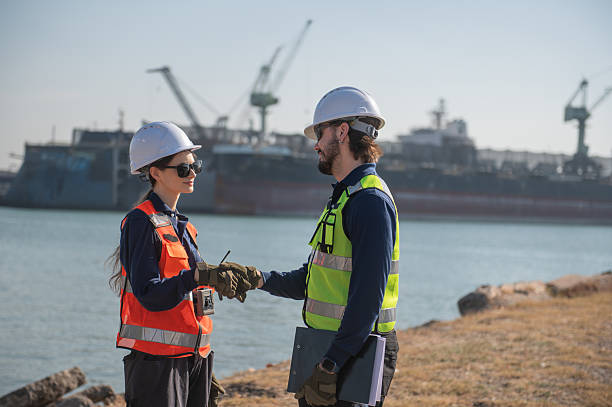 istock Professional engineering working at shipyard, Professional logistics monitoring cargo operations at industrial shipyard. 2254935866